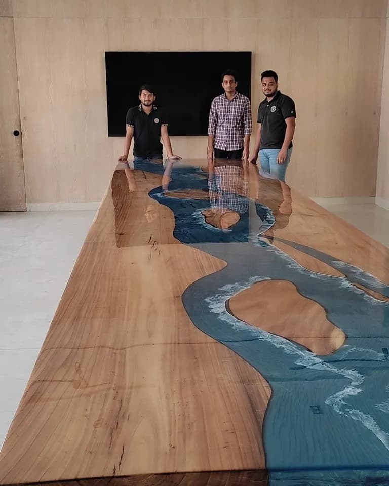 Our craftsmen behind a finished live edge river table in the workshop